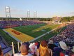 USFL Championship game wide shot of Tom Benson Stadium full of fans with players on the field, scoreboard and HOF Museum visible.jpg