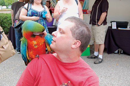 Photo-7---Torry-Sandlin-has-a-heart-to-heart-with-Harlequin-Macaw,-Kool-Aid.jpg